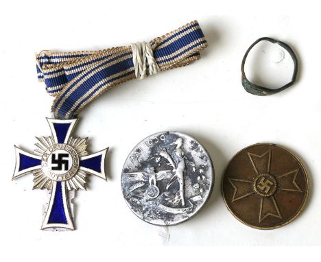 A WWII Third Reich white metal and enamel cross and medallions.