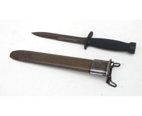 A scabbard for a US Army M1 bayonet, overall length 27cms (10.625ins) together with a US Army fighting knife with a blade len