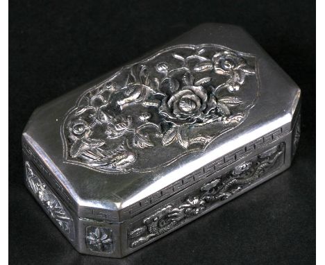 A Chinese silver snuff box of shaped rectangular form with embossed bird, flower and dragon decoration, 7.5cms (3ins) wide.Co