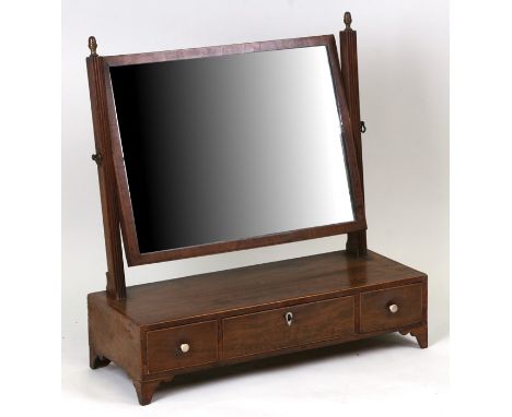 A 19th century mahogany toilet mirror with three short drawers, on bracket feet, 56cms (22ins) wide.
