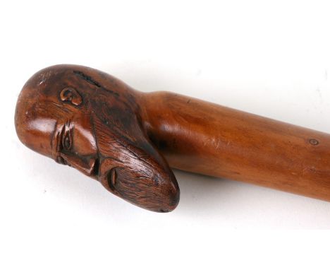 A Folk Art walking stick, the handle in the form of a bearded man, 90cms (35.5ins) long.