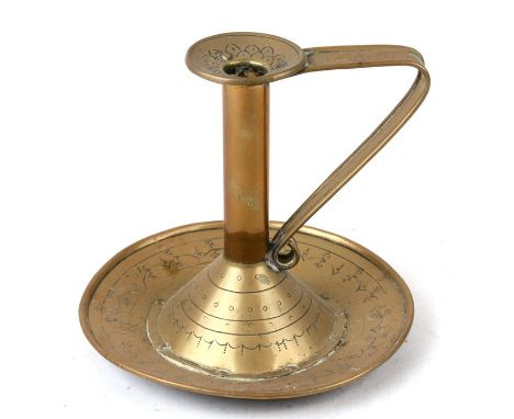A Christopher Dresser style brass candlestick, 18cms (7ins) high.