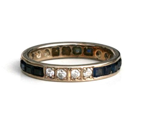 A diamond and sapphire eternity ring. Approx. UK size P