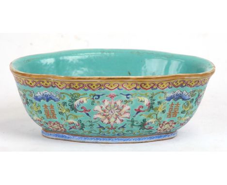 A Chinese famille rose shaped oval bowl decorated with flowers and characters on a turquoise ground, red seal mark to the und