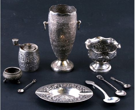 A quantity of Indian and Eastern silverwares including a pepper grinder, vases and spoons etc