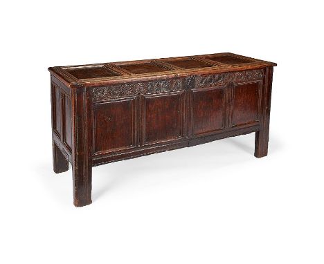 A Queen Anne oak panelled chest dated 1702
The four panel moulded lid above a running foliate roundel carved frieze with the 