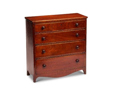 A Regency mahogany miniature narrow chest
Inlaid with boxwood lines, the rectangular top above four long graduated drawers, w