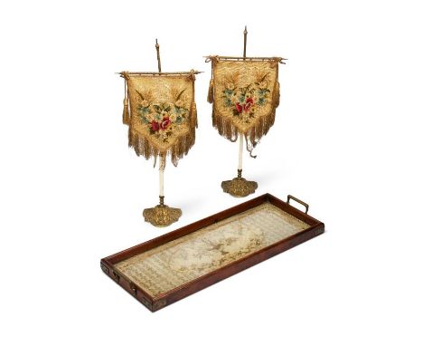 A late 19th century silk embroidered panel mounted in a tray and a pair of Victorian needlework face screens
The silk embroid