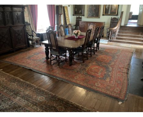 A large 19th Century iron red ground and light blue Turkish Carpet, with three rows of medallions, inside a multi floral deco