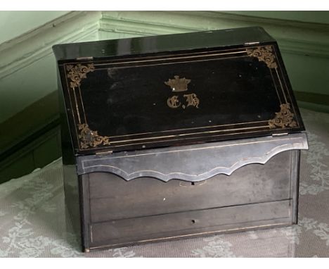 A brass inlaid ebonised slope front Stationary Box, with inlaid brass coronet and monogram, 12" (30cms) wide; a brass mounted