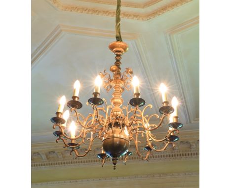 An antique Dutch wrought brass and brass 12 branch Ceiling Light, with multi knop stem and scroll arms and ball and urn termi