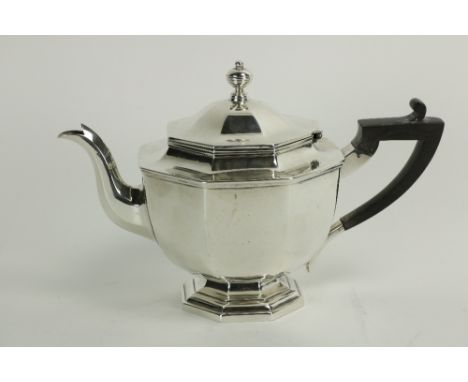 An octagonal crested silver Teapot, on stem base by Thomas Bradbury &amp; Son, London 1912, with ebonised handle, 719grs. (1)