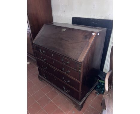 A George III period mahogany slope front Bureau, with fitted interior and four long graduating drawers on bracket feet, 36" (
