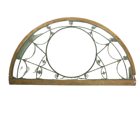 A fine Georgian pine and brass mounted demi-lune Fan Light,ÿthe central circular opening with a brass mount and a bead moulde