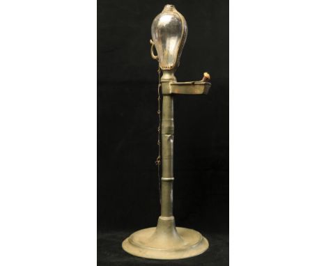 An 18th Century pewter Desk Light, with original glass bulbous oil container and finger handle on a turned stem with circular