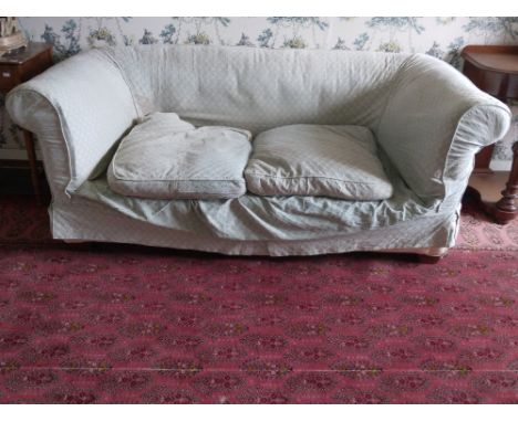 A late 19th Century Chesterfield Settee, covered in light blue loose fabric, with two loose cushions, 75" (191cms), together 