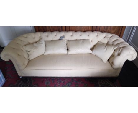 A Victorian Settee, of low proportions, covered in cream deep button fabric on ebonised turned feet, approx. 284cms wide (80"