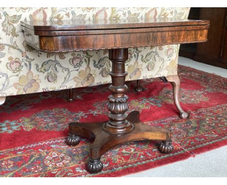 A very attractive Irish William IV rosewood fold-over Card Table, the turned and carved pedestal terminating on a quatra form