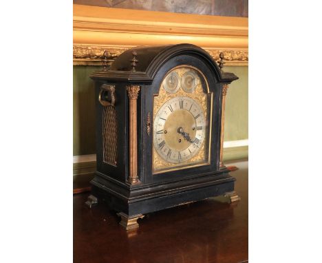 A good quality and attractive Victorian Bracket Clock, the arched top with brass finials, over a glazed door, with silvered a