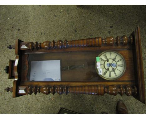 EARLY 20TH CENTURY WALNUT CASED VIENNA TYPE WALL CLOCK WITH OVERHANGING CORNICE AND BALUSTER TURNED HALF COLUMNS TO A SHAPED 