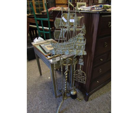 BRASS HAND IRON SET WITH SHIP MOUNTED STAND AND TWISTED BASE ON A TRIPOD WITH MATCHING SET OF HAND IRONS   