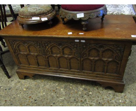 OAK FRAMED SMALL COFFER WITH DECORATIVE TOP ARCHED PANELLED FRONT RAISED ON SHAPED BRACKET FEET   