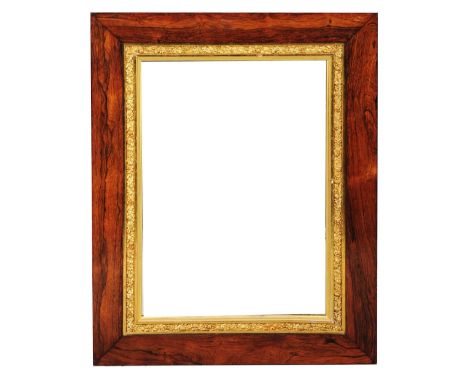 A LATE 19TH CENTURY ROSEWOOD FRAME, the gilt inner slip moulded with berried foliage and currently with mirror panel, rebate 