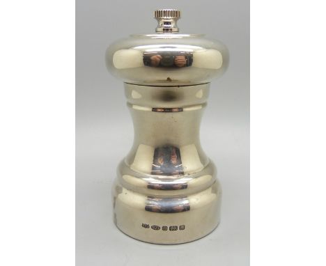 A silver pepper grinder 