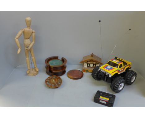 A Tandy remote control model vehicle, an artist's figure, a musical box, a small clock and coasters 