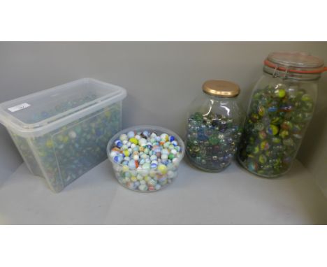 Four jars of vintage marbles 