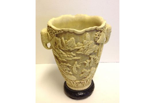 A large early 20thC faux ivory vase with elephant handles and a scenic ...