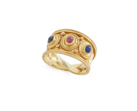 A Byzantine-style ruby and sapphire dress ring Collet-set with a cabochon ruby and two cabochon sapphires, beaded detail and 