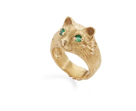 An emerald dress ring Modelled as a cat's face with textured detail, set with round-cut emerald eyes, stamped 750Dimensions:R