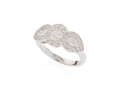A diamond cluster ring Collet-set with a round brilliant and two pear-shaped diamonds, in a border of round brilliant-cut dia