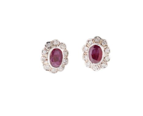 A pair of ruby and diamond cluster earrings Each collet-set with an oval-cut ruby in a border of round brilliant-cut diamonds