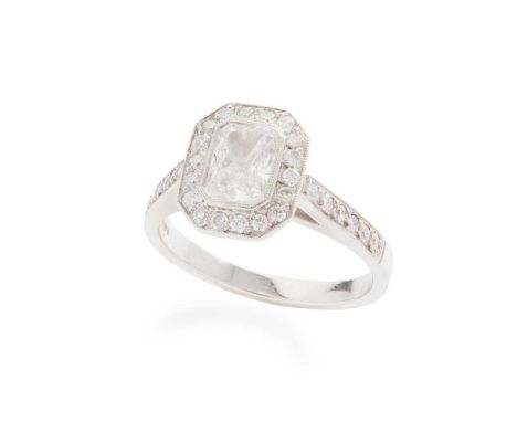 A diamond ring  Collet-set with a radiant-cut diamond in a border of round brilliant-cut diamonds, the shoulders similarly se