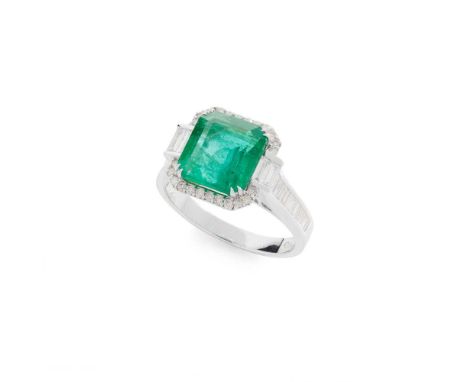 An emerald and diamond ring Claw-set with a cut-cornered square-cut emerald, in a border of round brilliant and baguette-cut 