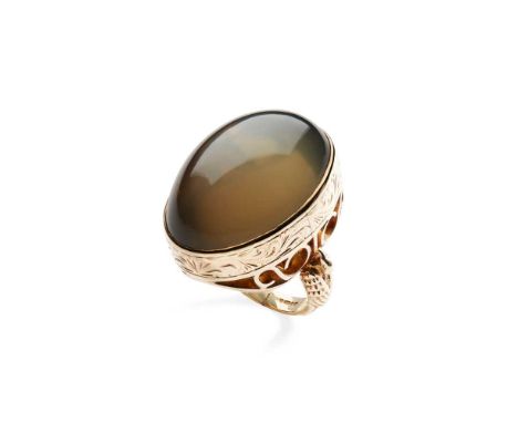 A large cabochon grey moonstone cocktail ring Collet-set with a large cabochon grey moonstone, cast bird detail to shoulders,