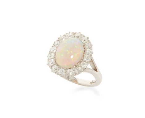 An opal and diamond cluster ring Claw-set with an opal cabochon in a border of old round-cut diamonds, modelled in 18ct goldD