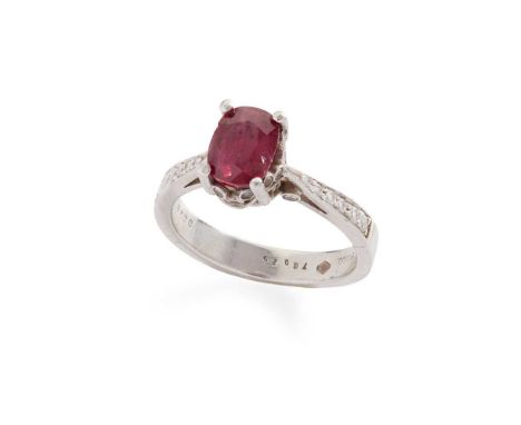 A ruby and diamond ring  Claw-set with an oval-cut ruby, the gallery and shoulders set with round brilliant-cut diamonds, sta