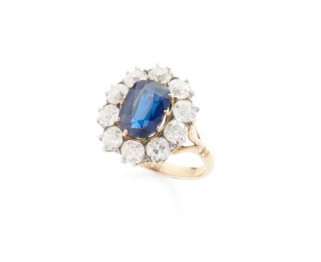 A sapphire and diamond cluster ring Claw-set with a cushion-cut sapphire, weighing approximately 3.70cts, in a border of old 