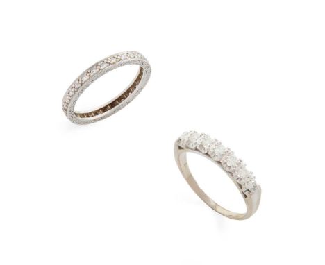 Two diamond rings The eternity ring set throughout with eight-cut diamonds, stamped PLAT; together with a diamond seven-stone