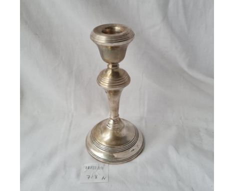 A candlestick with reeded rims 7 inches high 