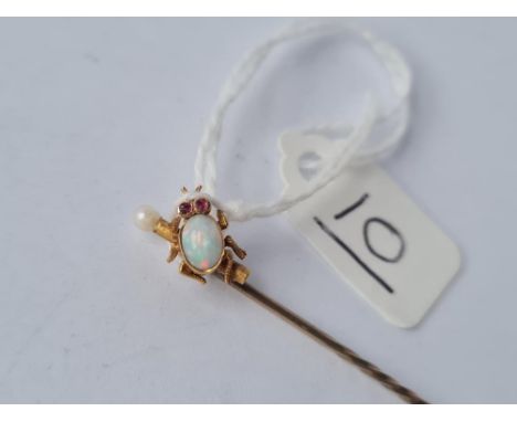 A Victorian opal set bug stick pin with ruby eyes in 15ct gold 