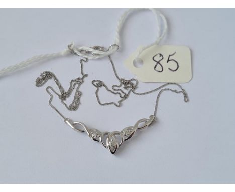 An attractive Celtic style pendant necklace set with diamonds in 9ct white gold