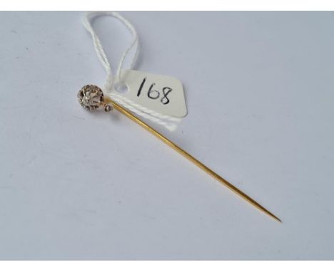 A nice gold umarked stick pin with diamond crown top in platinum