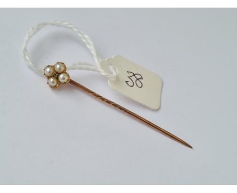 A small gold and pearl stick pin