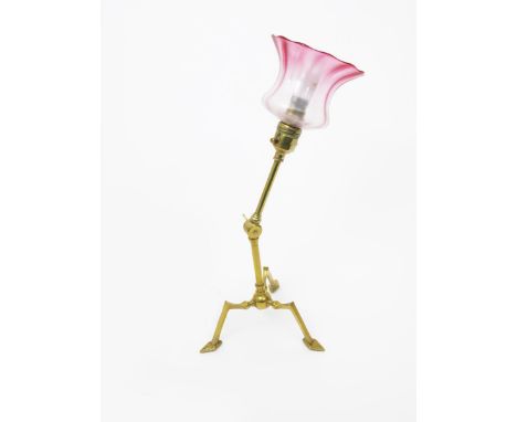 A W.A.S Benson brass table/wall lamp, on angular tripod foot, with articulated stem, frosted cranberry glass shade 42cm. high