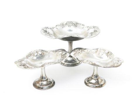 Three Holland Aldwinckle and Slater graduated silver tazza by Latino Movio, each bowl cast in low relief with various cornflo