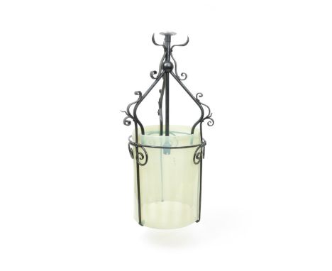 A large wrought iron hall lantern with vaseline glass shade the design attributed to W.A.S Benson, unsigned 64cm. high